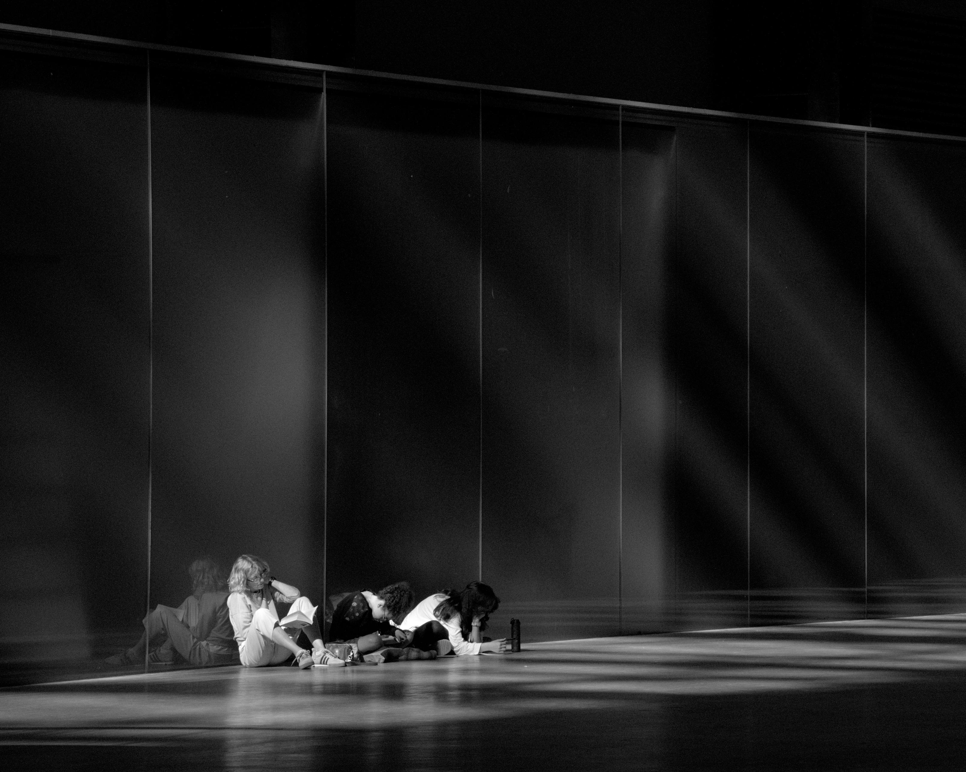 A group of people finds a quiet spot in the monumental space of the Tate Modern Turbine Hall