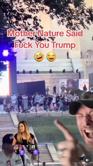 Still of the video. People on the National Mall who hoped to see Trump's celebration (all white, no surprises there) are running through pouting rain. In the foreground is the owner of this account, a white man wearing a ballcap, pointing and laughing. Text reads "Mother Nature Said Fuck You Trump"