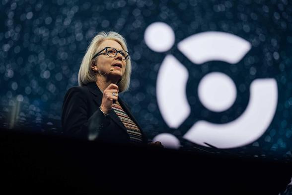 woman presenting on a big stage