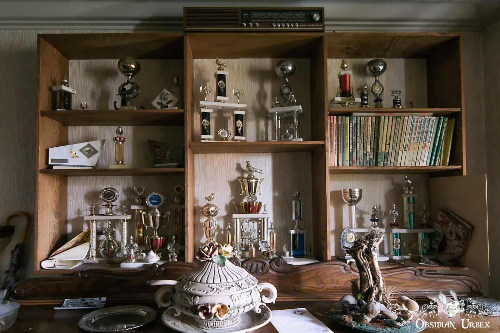 Book case of trophies and magazines