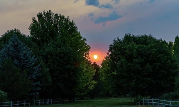 There are wildfires on the western side of Colorado, the biggest of which, the Snyder fire, is over 28,000 square miles (72.000 square kilometers) with 0% containment. Here’s a photo from my backyard showing the sun as it appeared tonight, through 250 miles of smoky haze. June 2026