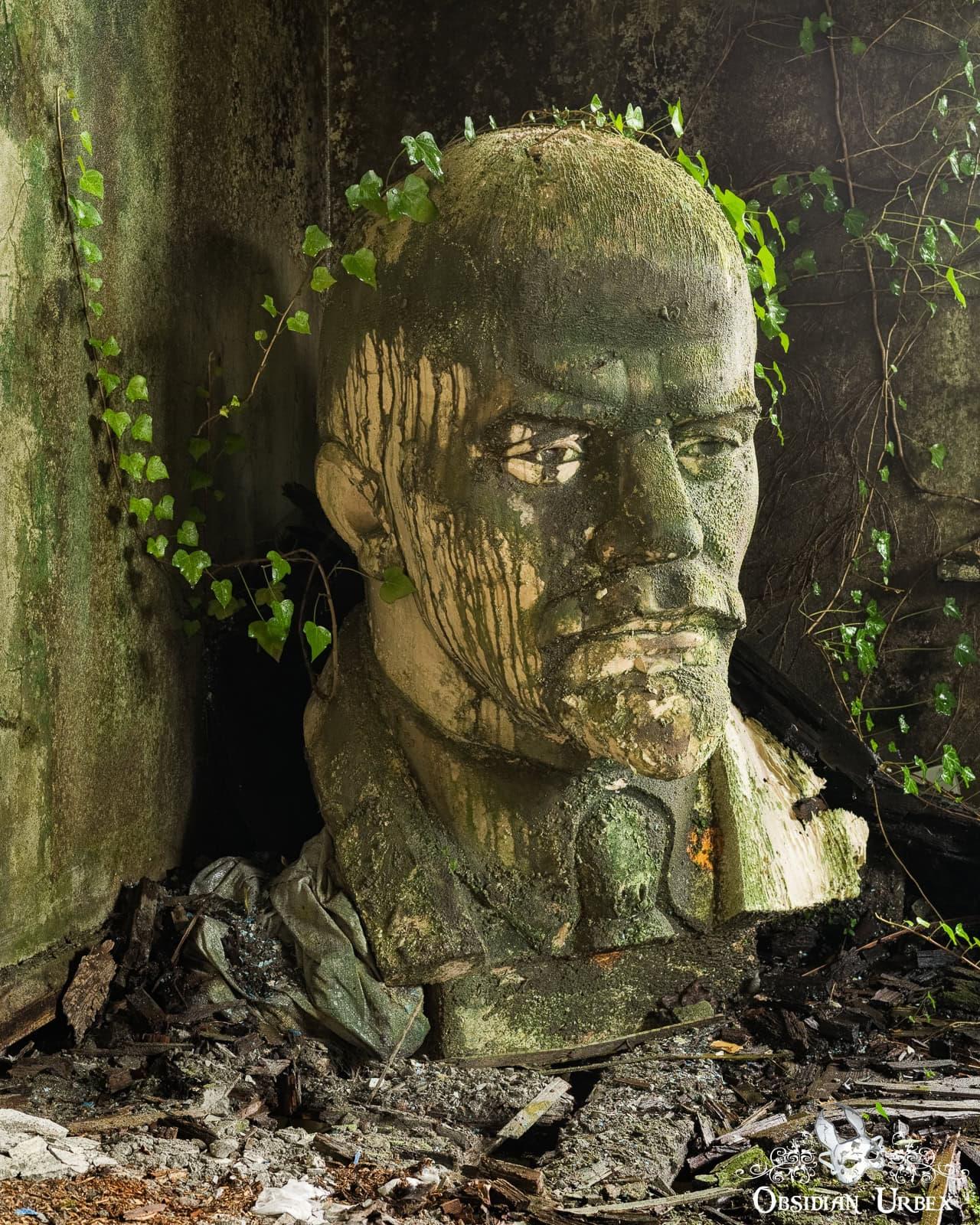 Bust of Lenin with ivy growing over
