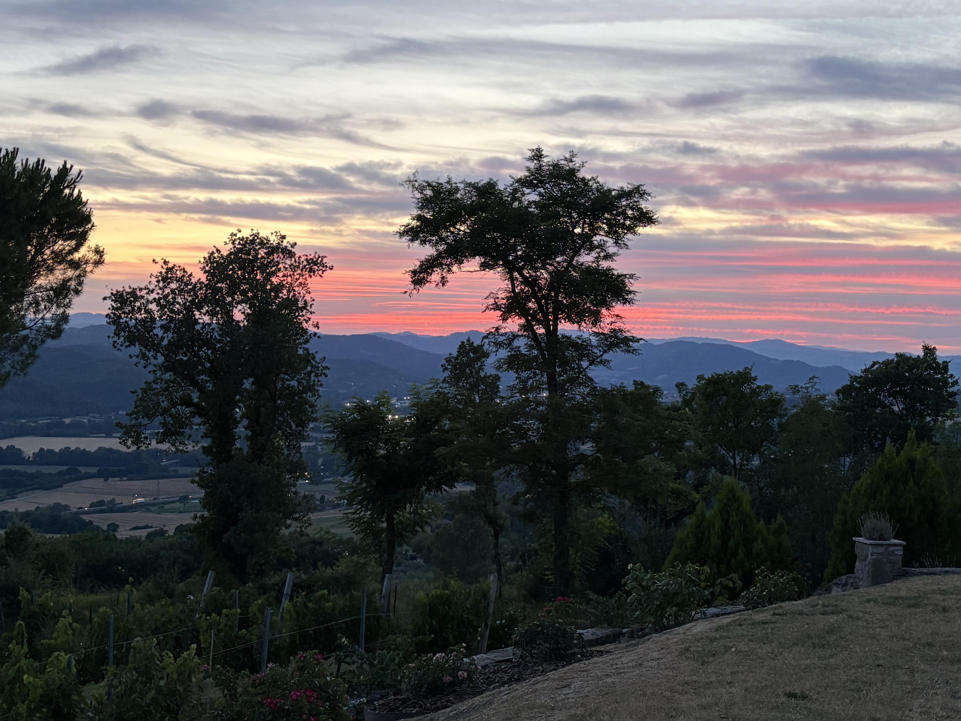 A brilliant sunset with stripes of red and purple, over the hills of the upper Tiber Valley.