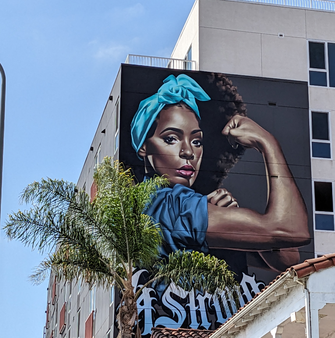 Mural of a black woman posed similarly to Rosie the Riveter. LA Strong