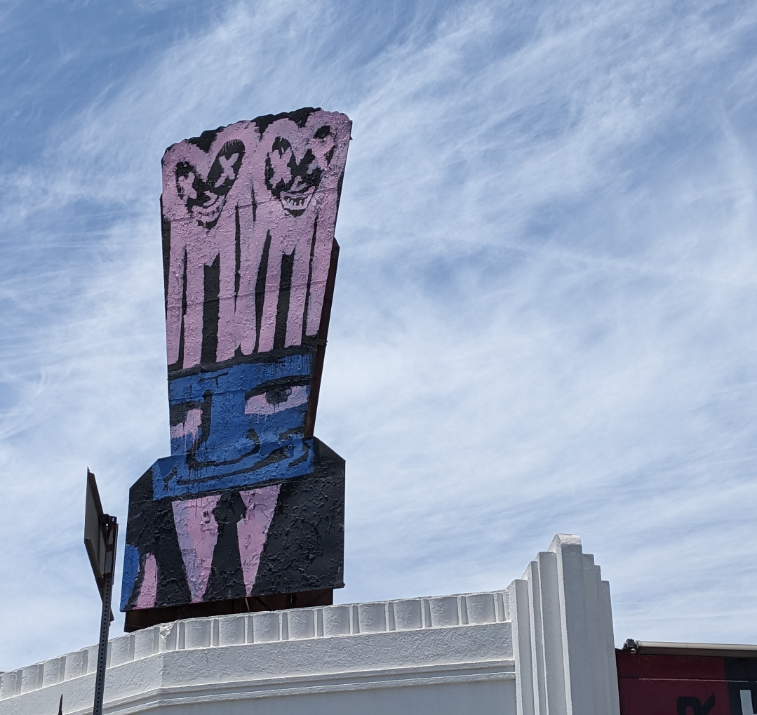 Distinctive slouchy business guy and Heart faced street art