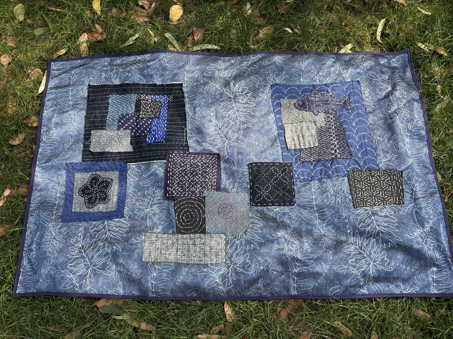 The more abstract, less square side of the table mat, with sashiko fish top right