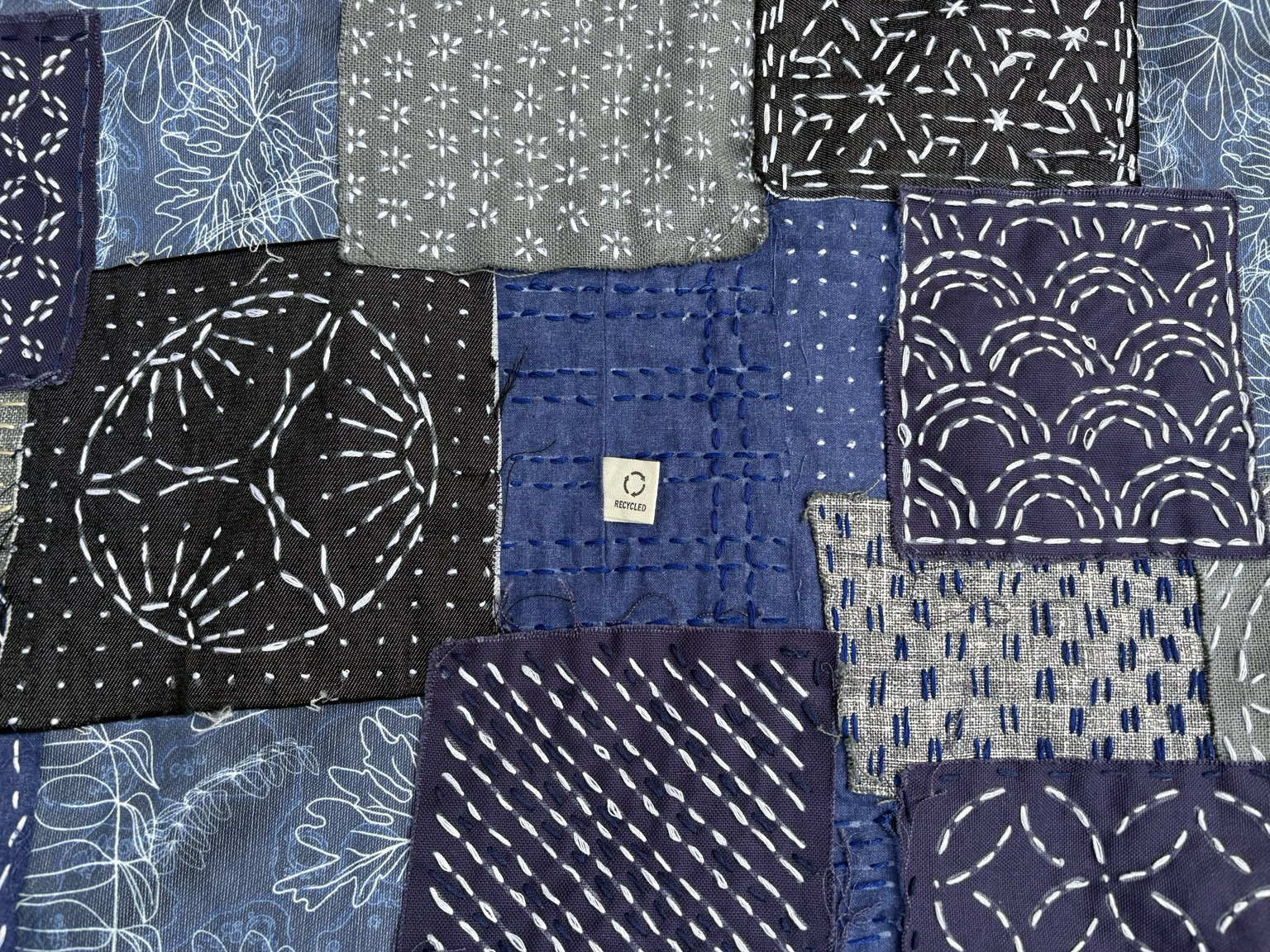 Close-up of table mat, with recycled label