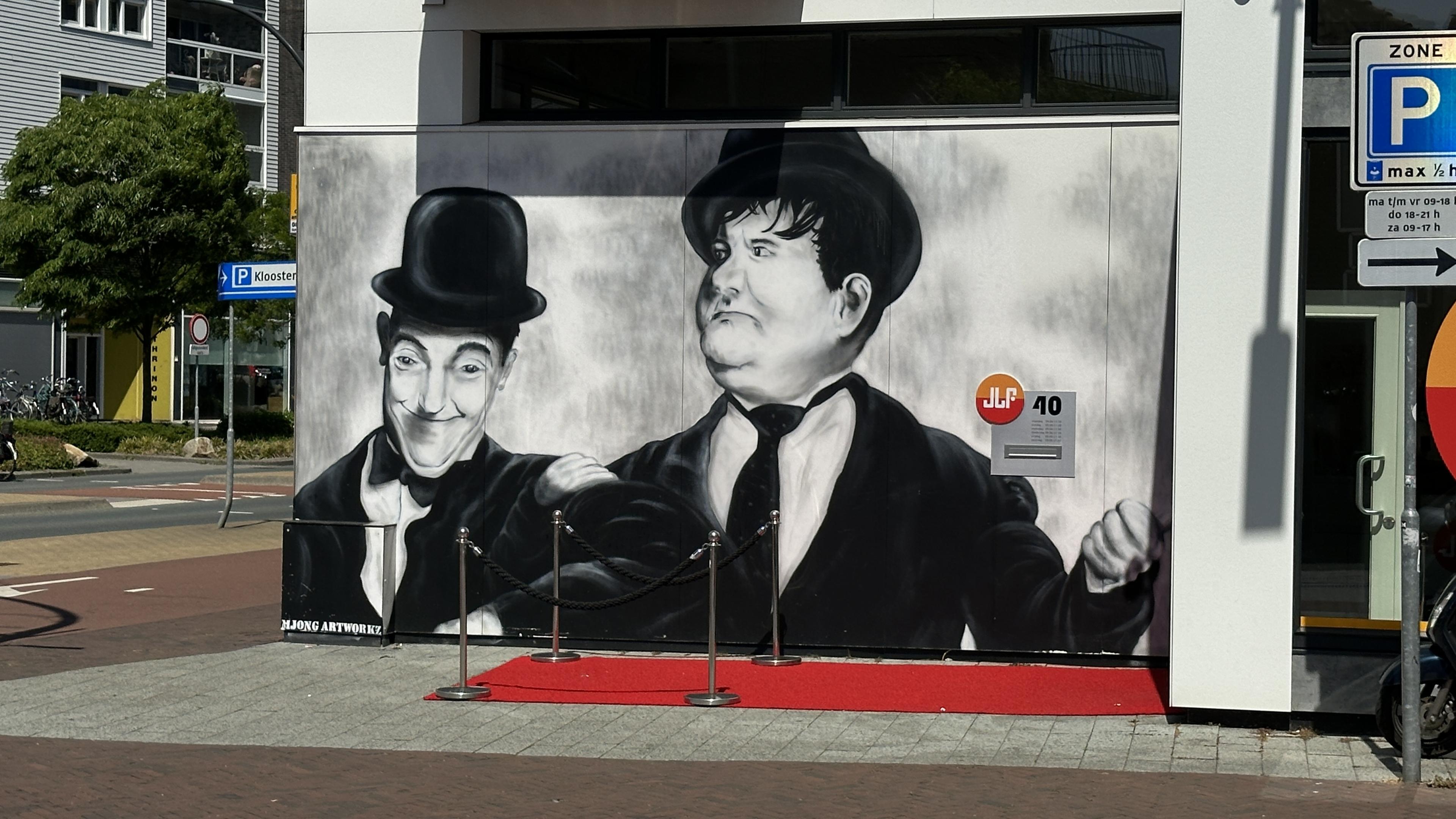 Black and white street art ish of the comedian duo Laurel and Hardy in a local city