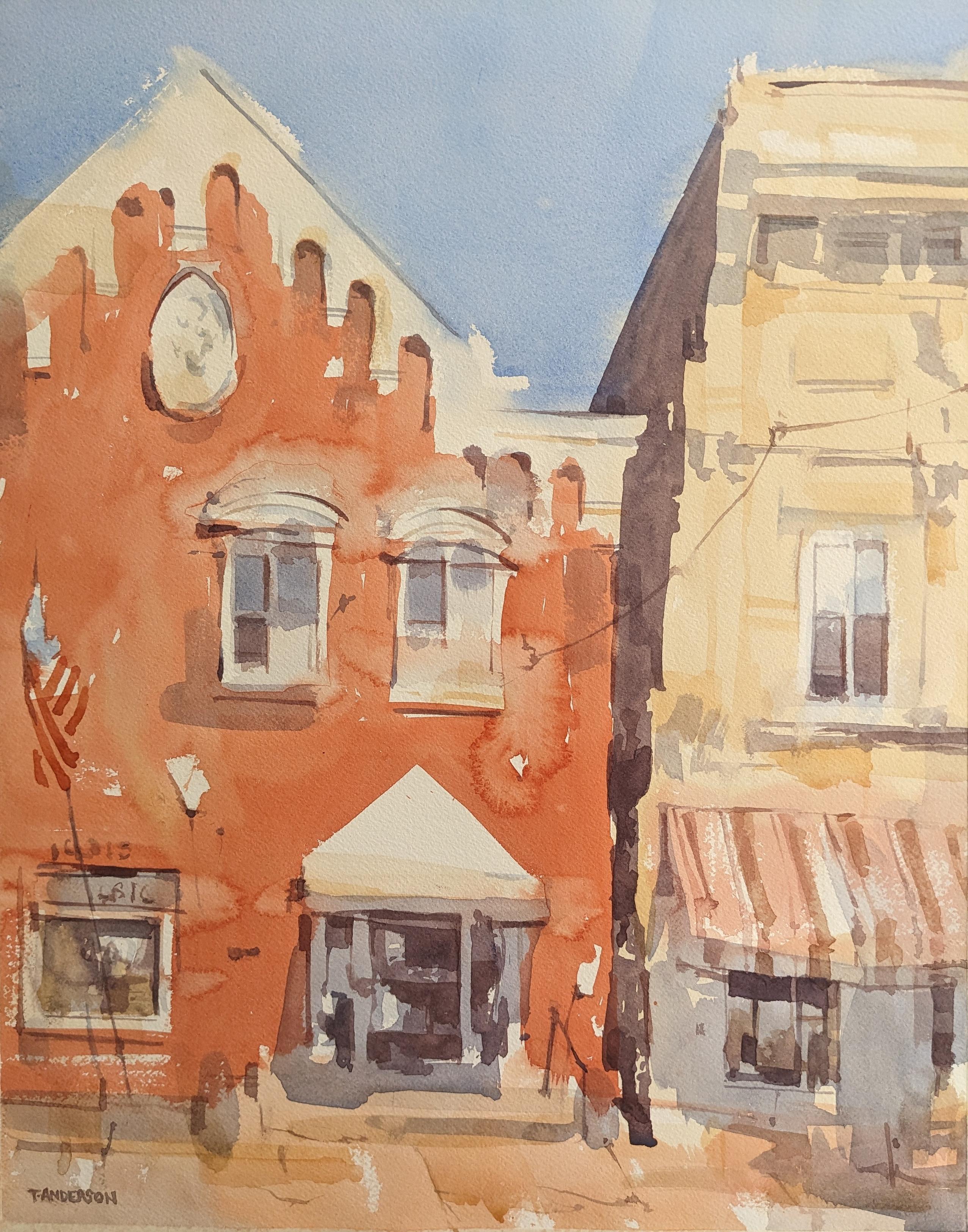 Watercolor painting of buildings along North Main Street in Salem, New York. A large red brick building with a peaked roof and ornate white wood trim sets on the left. It has two arched windows in white trim on its second floor below a large white oval plaque. On the ground floor, an entry with a sharp white canopy casts a shadow on windows and doors. To its left, a flag hangs limp in front of a storefront window. To the right of the brick building is a multiuse yellow stucco building with upper floor apartments and a ground floor storefront - its windows and entry covered in shade from a yellow and red stripes awning.