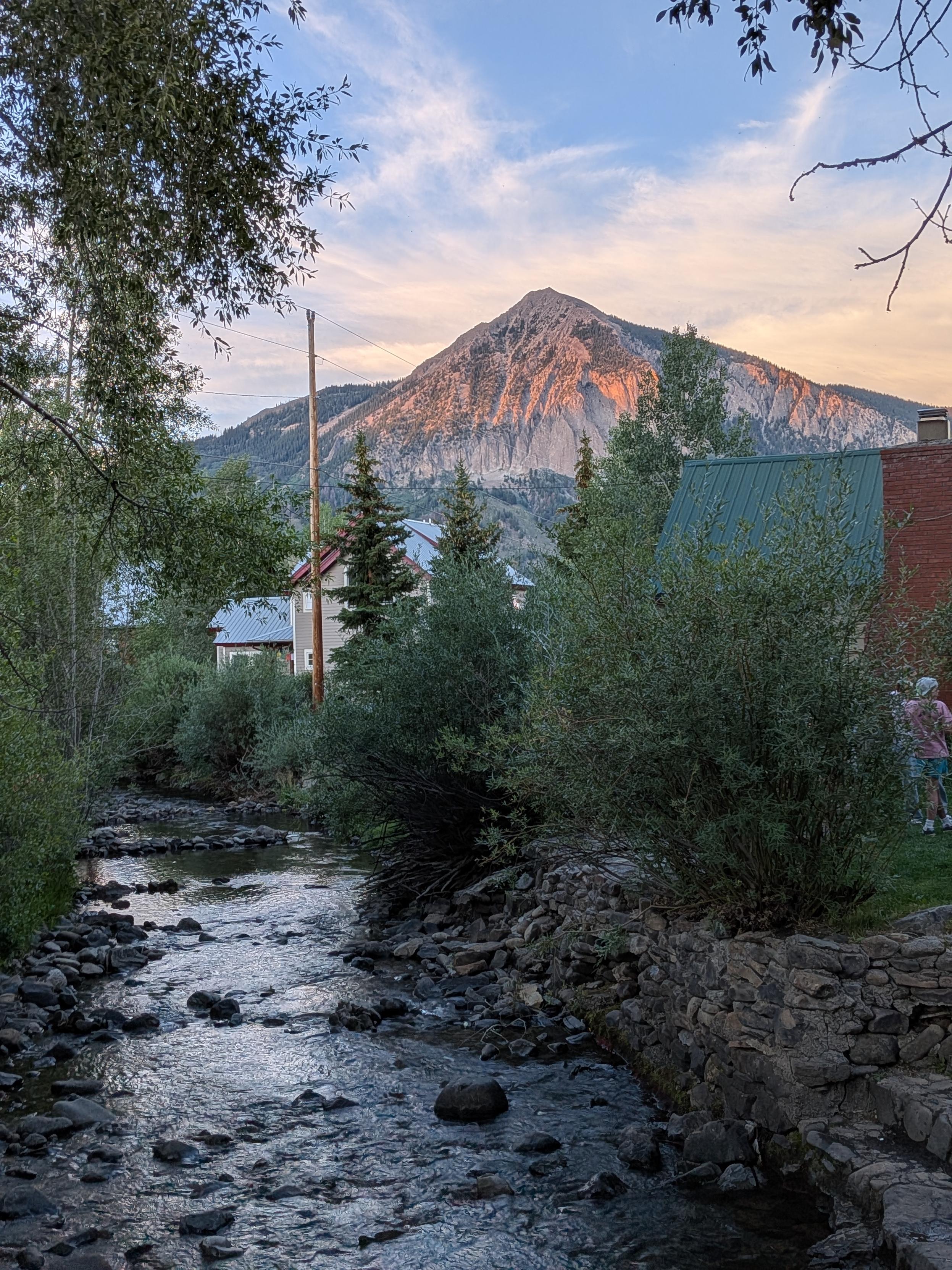 A mountain in the last rays of sun above a creek