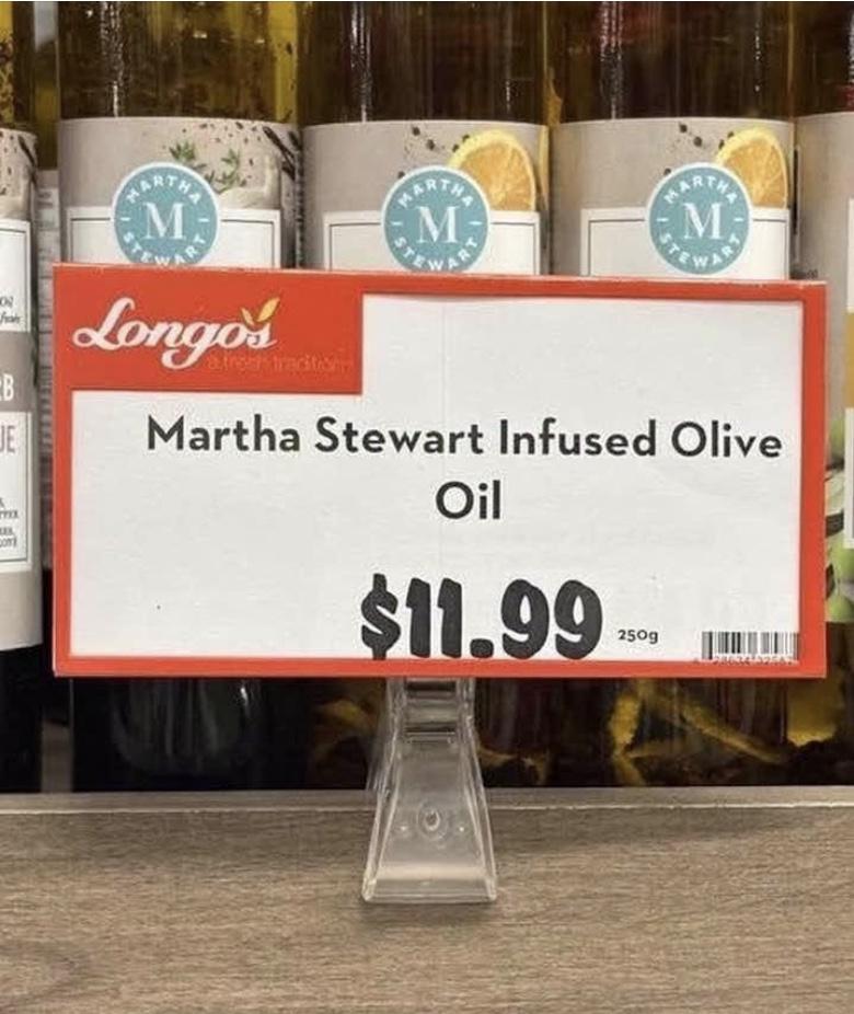 Display sign in a supermarket (Longo's, which is a Toronto-area chain), advertising "Martha Stewart infused olive oil"