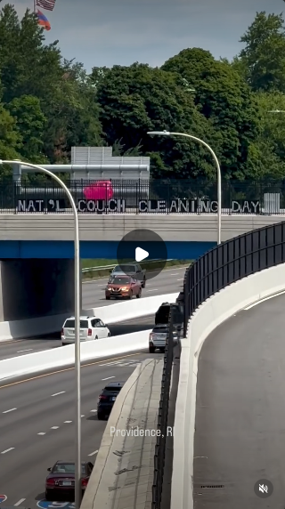 On a bridge in Providence, Rhode Island, there's a big black and white banner that say "NAT'L COUCH CLEANING DAY" and an inflatable pink couch visible from the road.  Their banner on the other side says "HONK CUZ JD VANCE IS WEIRD AF." They also have US flags and flags with hearts in Pride and Trans colors, Black Lives Matter, and peace hearts. There is extensive sidewalk chalk on the bridge making fun of JD Vance, including a picture of a couch saying "Noooo!"