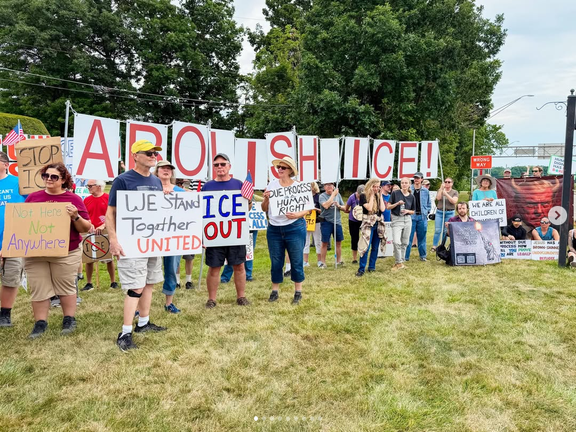 Part of one protest at CAK airport. A crowd is standing around with letters that spell "ABOLISH ICE!" as well as a bunch of individual signs that say things like "Due Process Is a Human Right," "We Stand Together UNITED," "Not here not anywhere," and "ICE OUT."