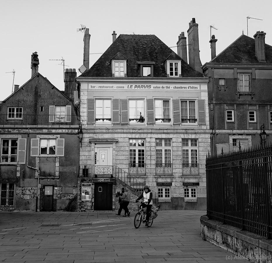 Cyclist and buildings in Chartres, France
