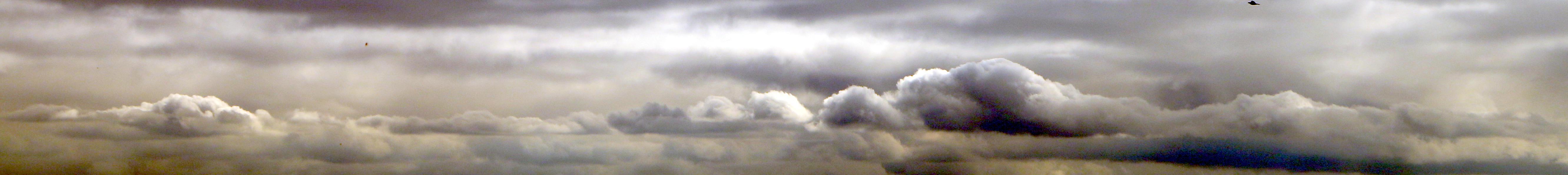 Super-wide crop of a skyscape centring a line of cloud dramatically lit with white highlights above and very dark, almost black contrasting shadowed undersides.

Canon EOS 70D
ISO: 100
Shutter Speed: 1/500
Aperture: 10.0

Lens: 18.0 - 135.0 mm
Focal Length: 98.0 mm (35 mm equivalent: 154.5 mm)
Hyperfocal Distance: 50.40 m
Depth Of Field: inf (44.35 m - inf)
Field Of View: 13.3 deg

GPS Position: 51°25'17.4"N 0°04'33.6"W
Location Name: Corner of the Crystal Palace           
Location: Crystal Palace Park
City: London Borough of Bromley              
Country: United Kingdom

2025:10:17 12:11:35
Copyright: Matthew Malthouse © 2025