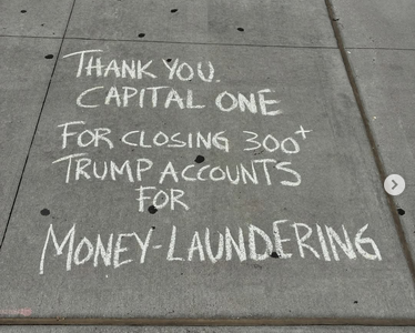 Protestors have chalked on the sidewalk outside Capitol One in NYC: "THANK YOU CAPITAL ONE FOR CLOSING 300+ TRUMP ACCOUNTS FOR MONEY LAUNDERING."
