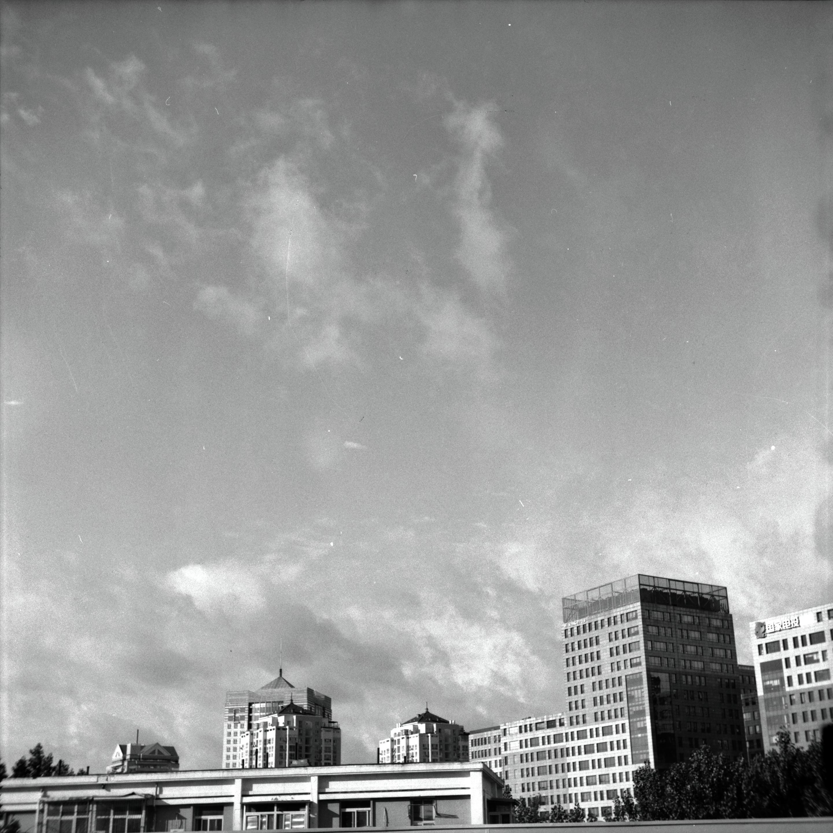 Lucky LUCKY SHD 100 (6x6)

English
A black-and-white photograph of a city skyline with a focus on the sky. The sky is filled with scattered clouds, and the sunlight creates a soft, diffused light effect. Below the sky, there are multiple modern high-rise buildings with varied architectural designs, including glass facades and unique rooftops.
中文
一张黑白城市天际线的照片，重点在天空上。天空中散布着云层，阳光制造出柔和的漫射光效果。天空下方是多栋现代高层建筑，建筑设计各异，包括玻璃立面和独特的屋顶。