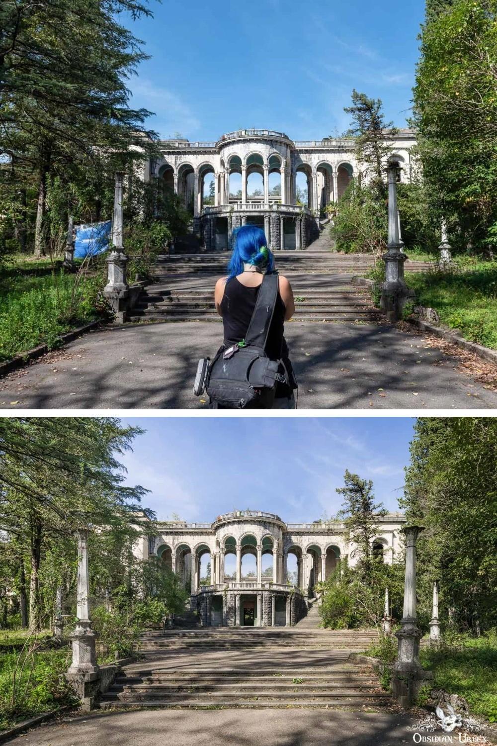 A person with blue hair stands on steps leading to an abandoned, two-story building with arches, surrounded by overgrown vegetation and tall trees.