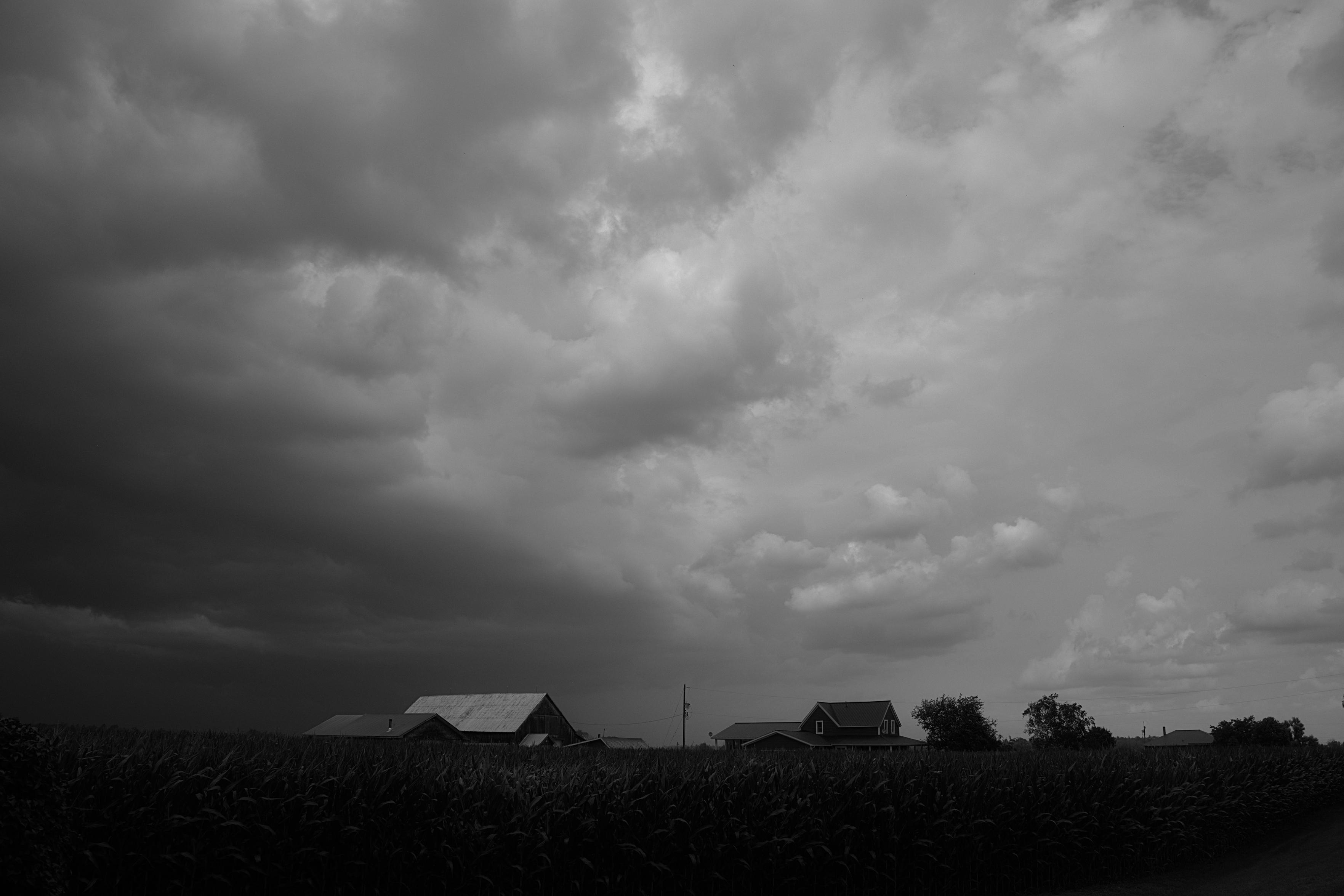 Wild clouds move in over a farm.