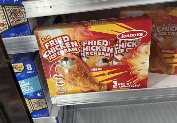 Photo of a freezer case at a grocery store showing a new product: Fried Chicken ice cream. 