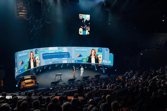 two women giving presentation on stage