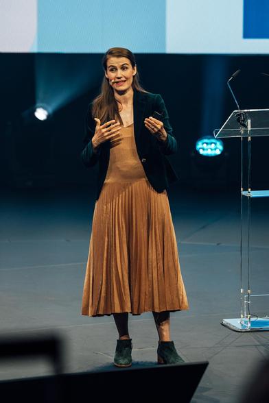 woman giving presentation on stage