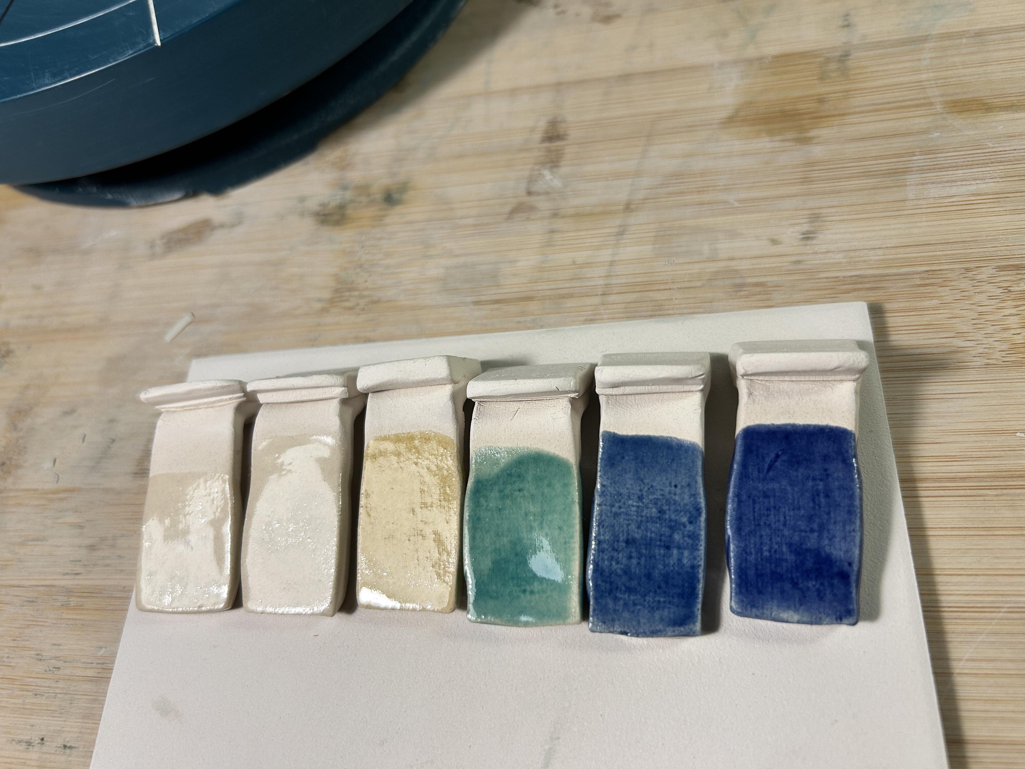 Backs of each test tile, where they received two coats of brushed on glaze - super shiny!