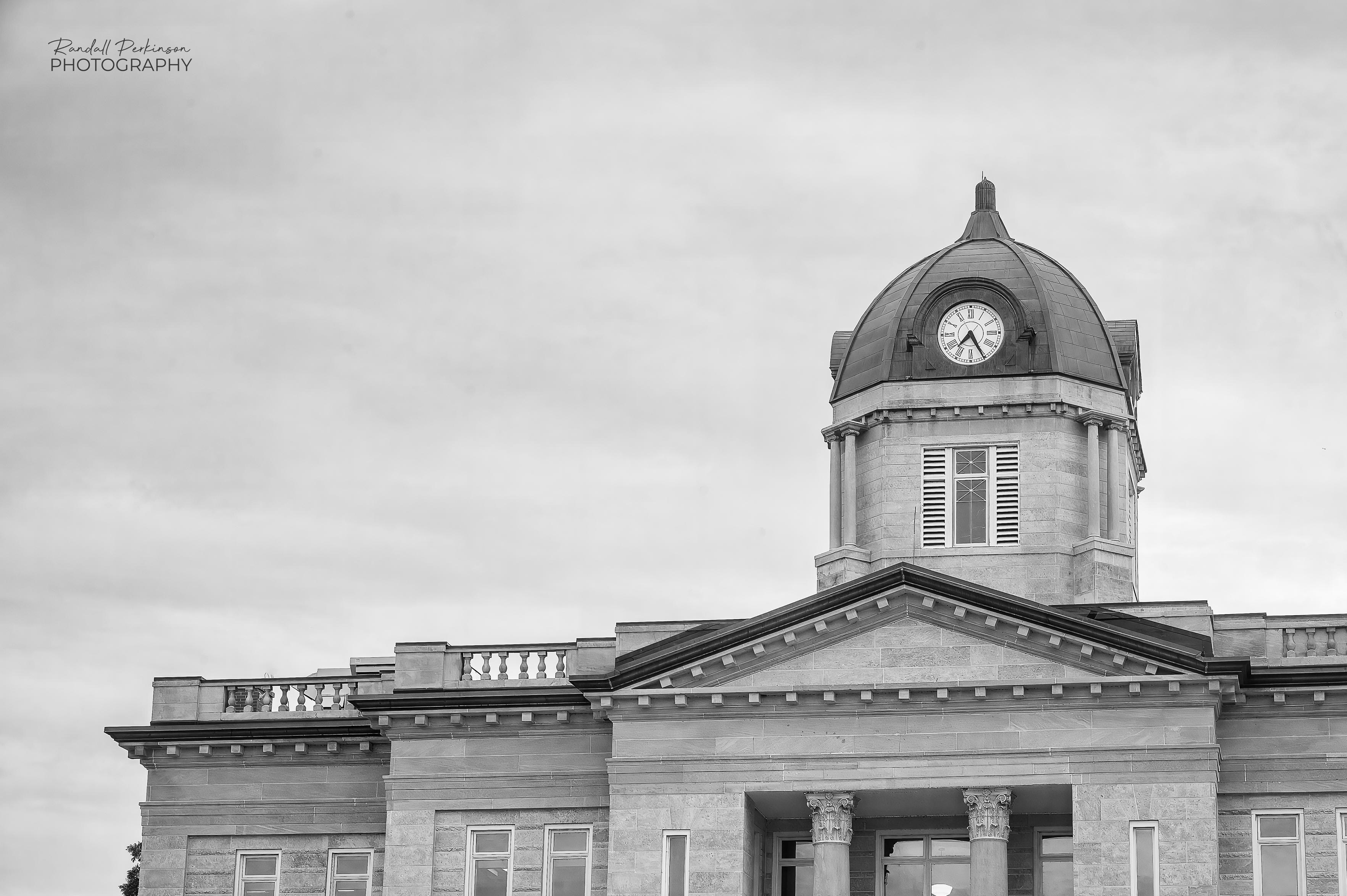 A black and white view of the upper portion of the Cape Girardeau County Courthouse including the dome at the center of the building.