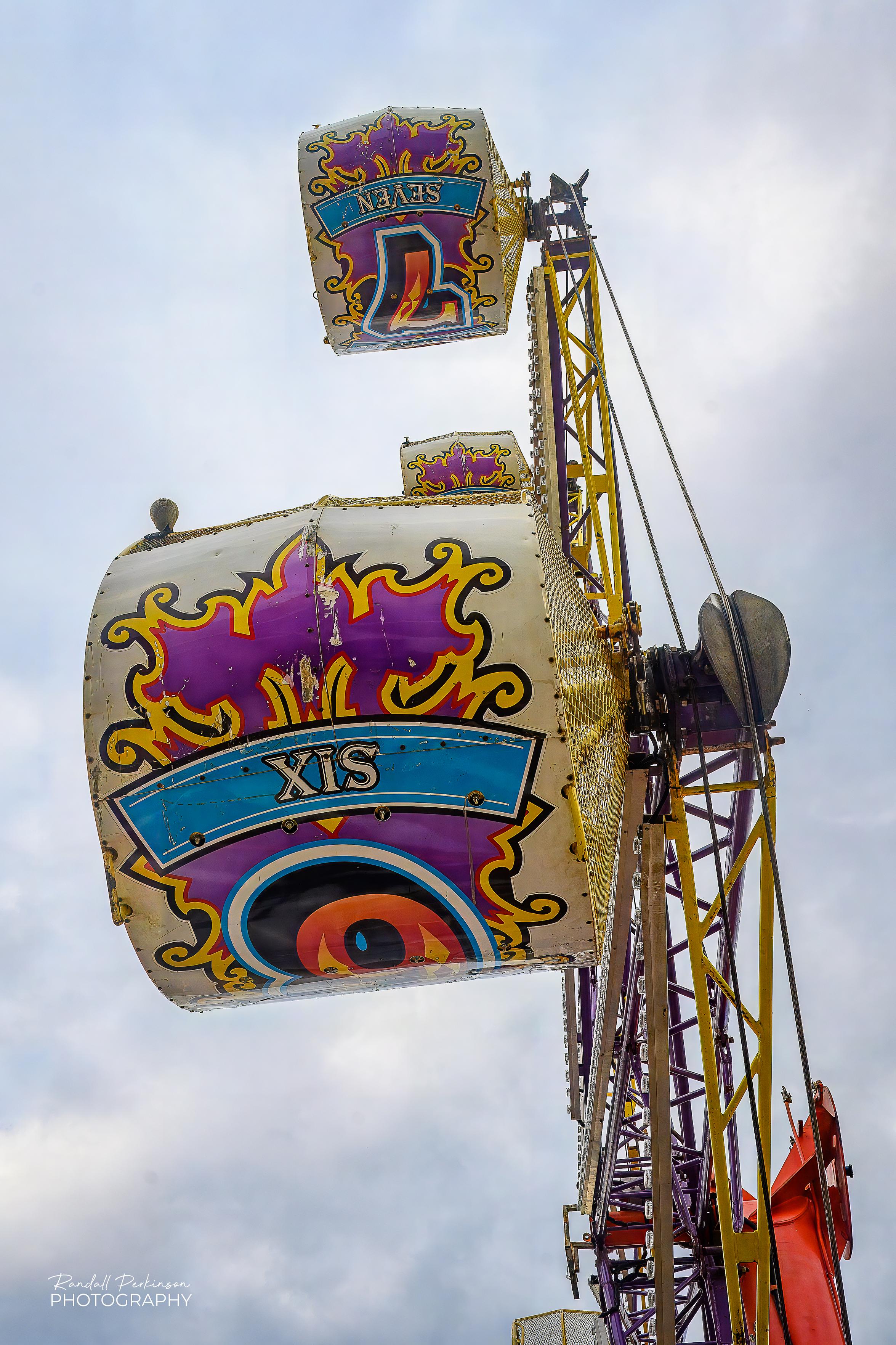 Looking up at Cars 6 and 7 of the Rock-O-Plane carnival ride.
