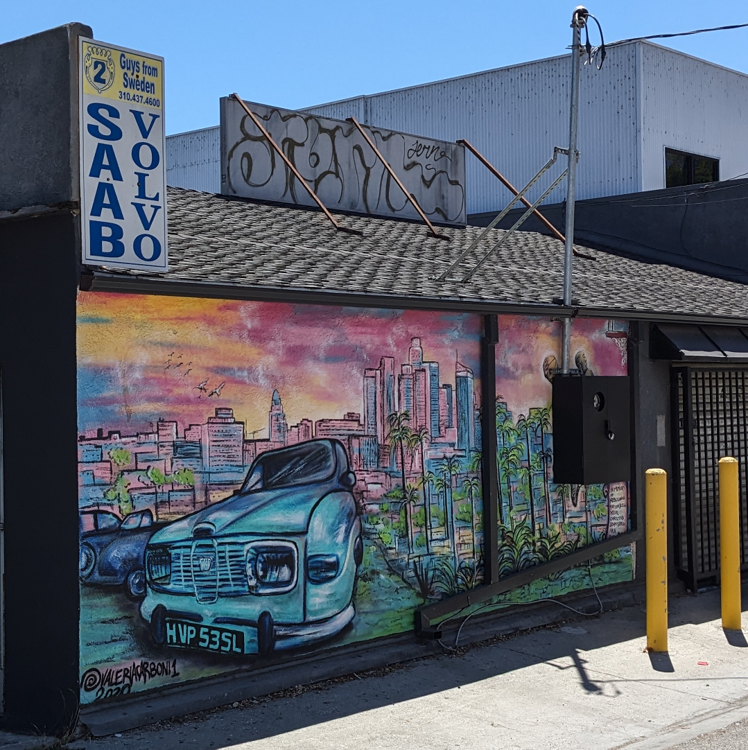 Mural behind a Saab mechanic featuring a Saab