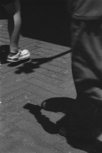 Ilford HP5 Plus 400 (FF)

English
A black and white photograph. The photo was taken from a lower angle of two people walking on a tiled road. Shadows of the people and street lamp can be seen as well. Strong contrast.

中文
一張黑白照片.照片低角度拍攝.兩個人走在磚塊鋪砌的路上.行人的影子和街燈的影子都清晰可見.強烈的反差.