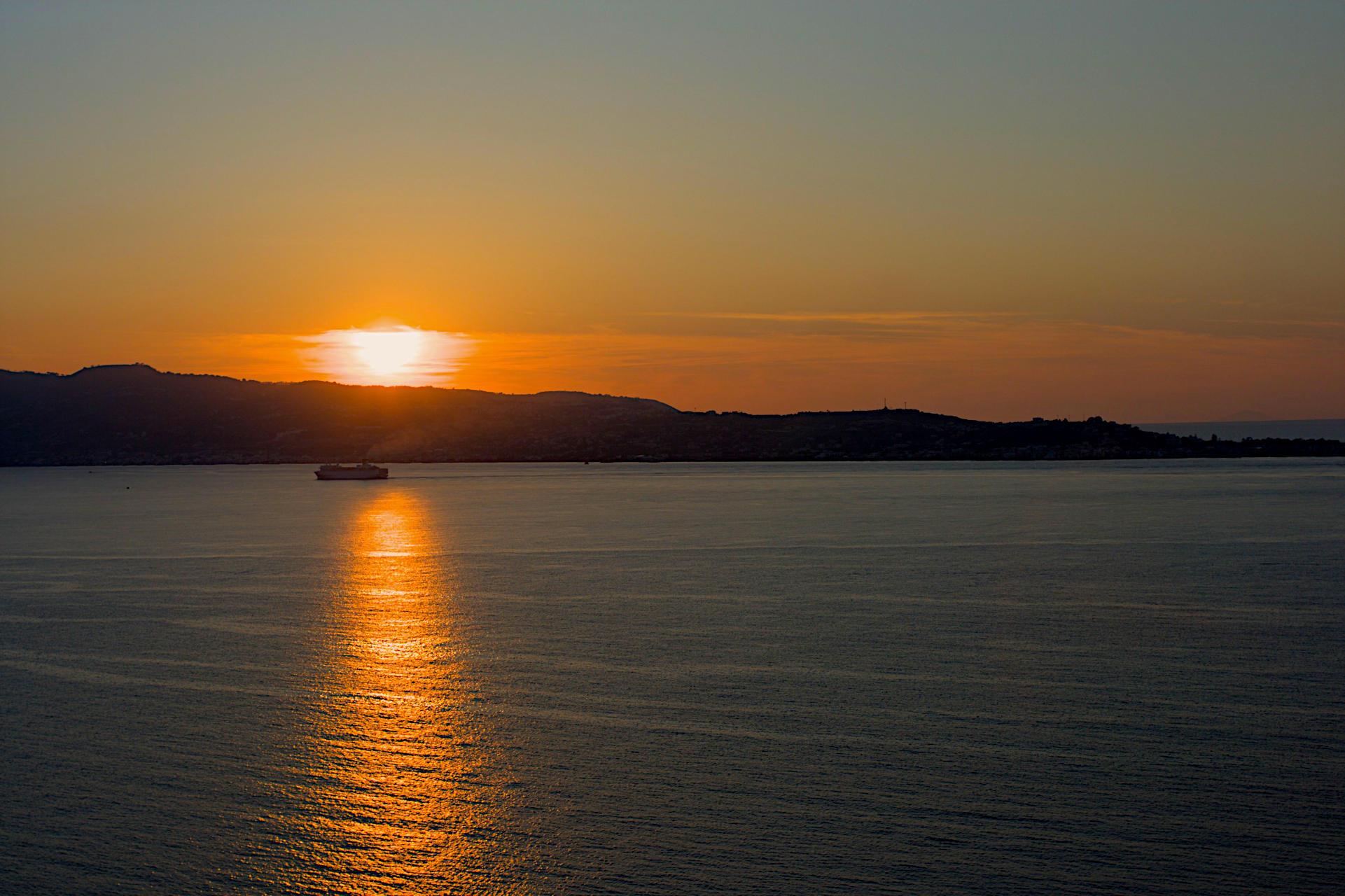 The sun going down behind a spit of land makes a streak of light across calm sea waters. A ferry in the sistance is just between the shore and the reflected orange light.

Canon EOS 400D DIGITAL
ISO: 100
Shutter Speed: 1/320
Aperture: 6.3

Lens: 35.0 mm
Focal Length: 35.0 mm (35 mm equivalent: 56.6 mm)
Hyperfocal Distance: 10.47 m
Field Of View: 35.3 deg

GPS Position: 38 deg 12' 17.7" N, 15 deg 35' 01.0" E

2008:04:28 17:31:05Z (19:31:05 CEST)
Copyright: © Matthew Malthouse 2008