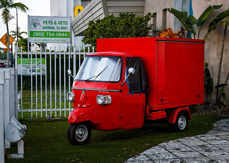 Red Piaggio tricycle van