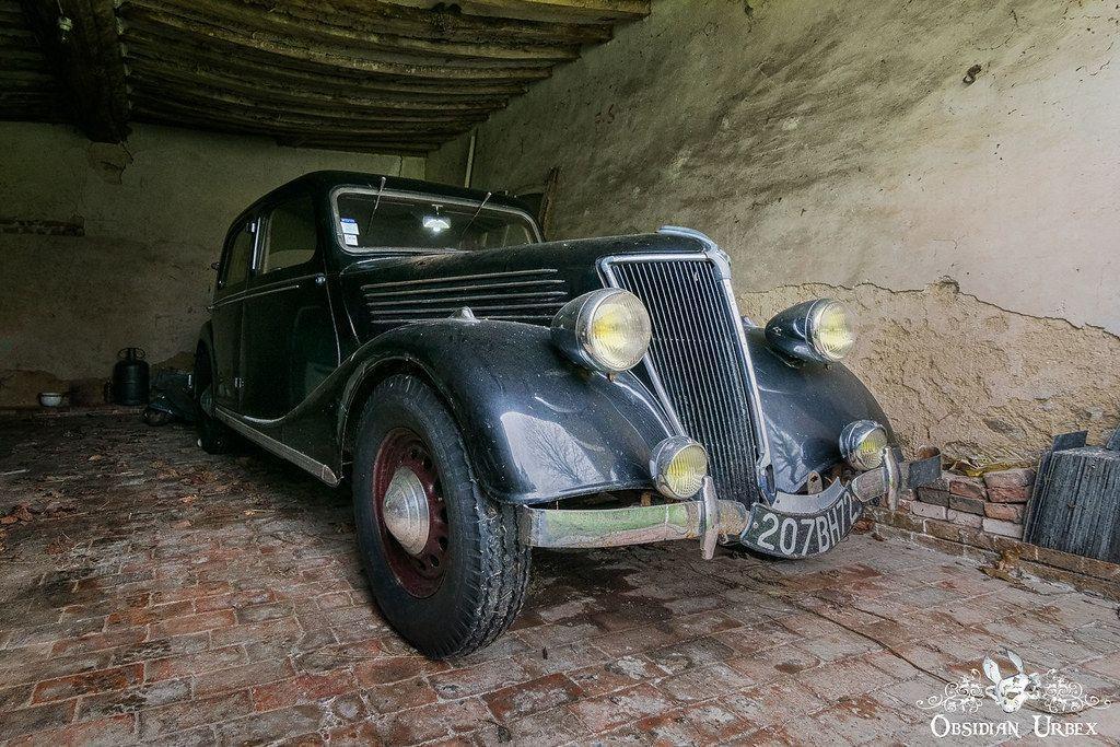 old 1930s style car in an old garage