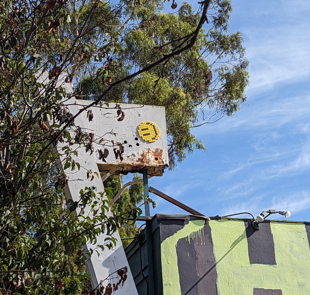 Tiled happy face on a sign