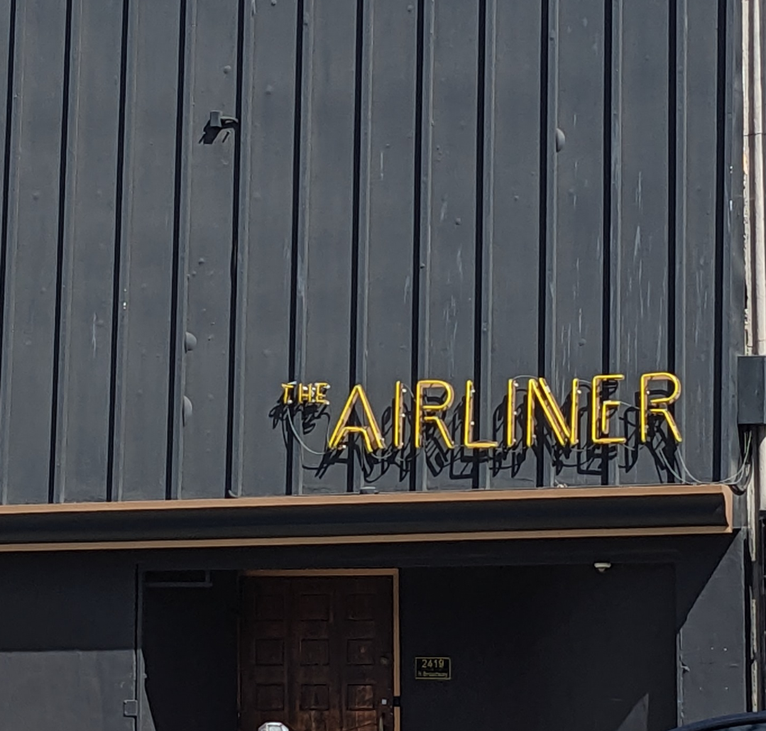 Dark building with a sign saying The Airliner