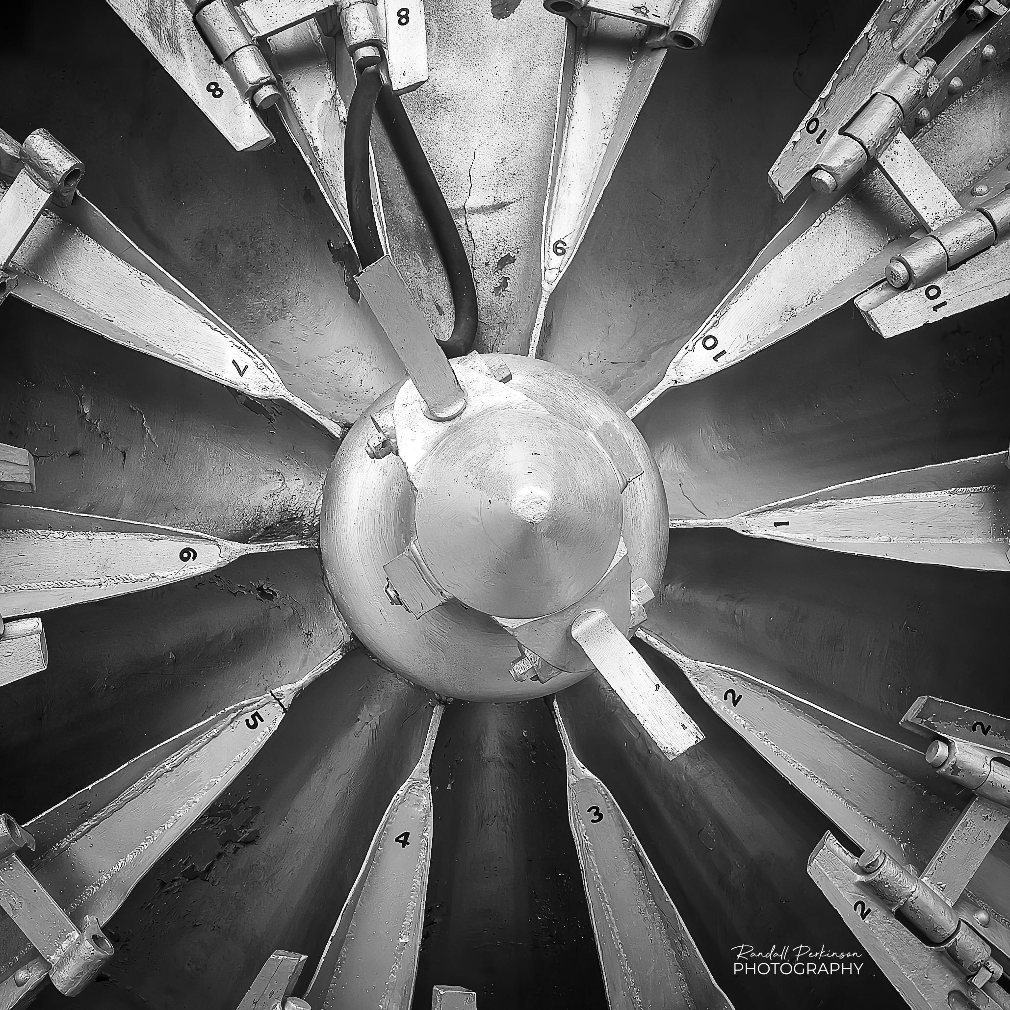 The view of the center of the 10 blades of a Union Pacific rotary snowplow.  The center has a cone shaped cover and the individual blades are numbered 1 to 10 in black numbers on each blade.