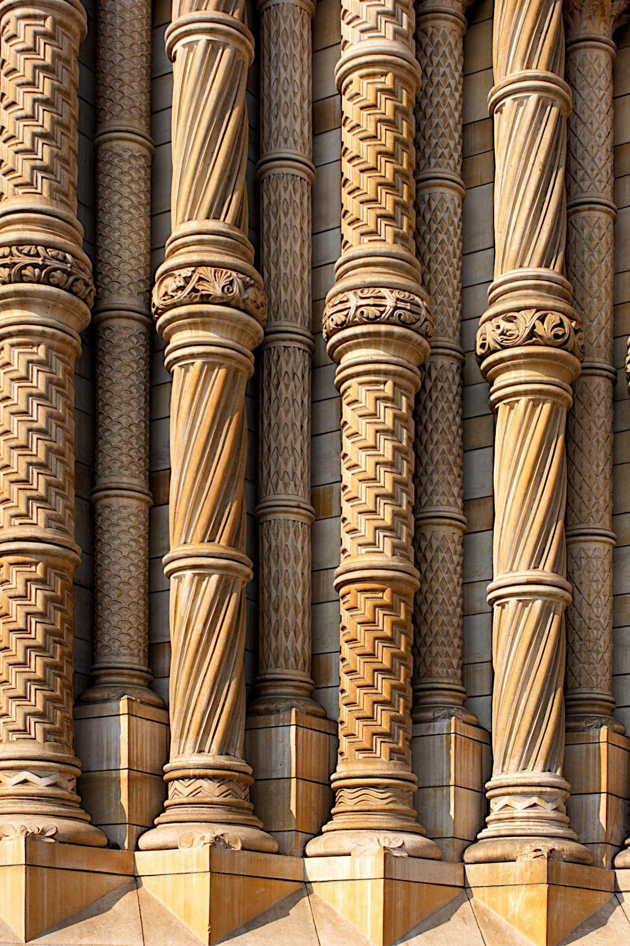 Columns formed of terracotta blocks in a highly decorated Romanesque style around wrought iron stanchions framing the main entrance to the Natural History Museum, Kensington, London.

Canon EOS 400D DIGITAL
ISO: 100
Shutter Speed: 1/400
Aperture: 6.3

Lens: 35.0 mm
Focal Length: 35.0 mm (35 mm equivalent: 56.6 mm)
Hyperfocal Distance: 10.47 m
Field Of View: 35.3 deg

GPS Position: 51 deg 29' 45.4" N, 0 deg 10' 34.8" W
Natural History Museum, Cromwell Road, South Kensington, London, UK. 

2011:03:25 12:17:47
Copyright: © Matthew Malthouse