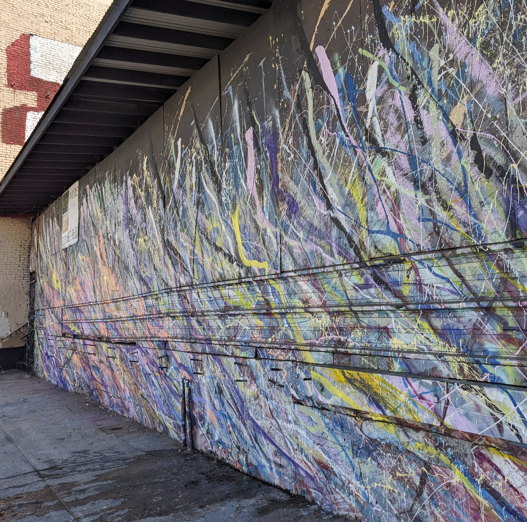 Multi colored paint drips on a door