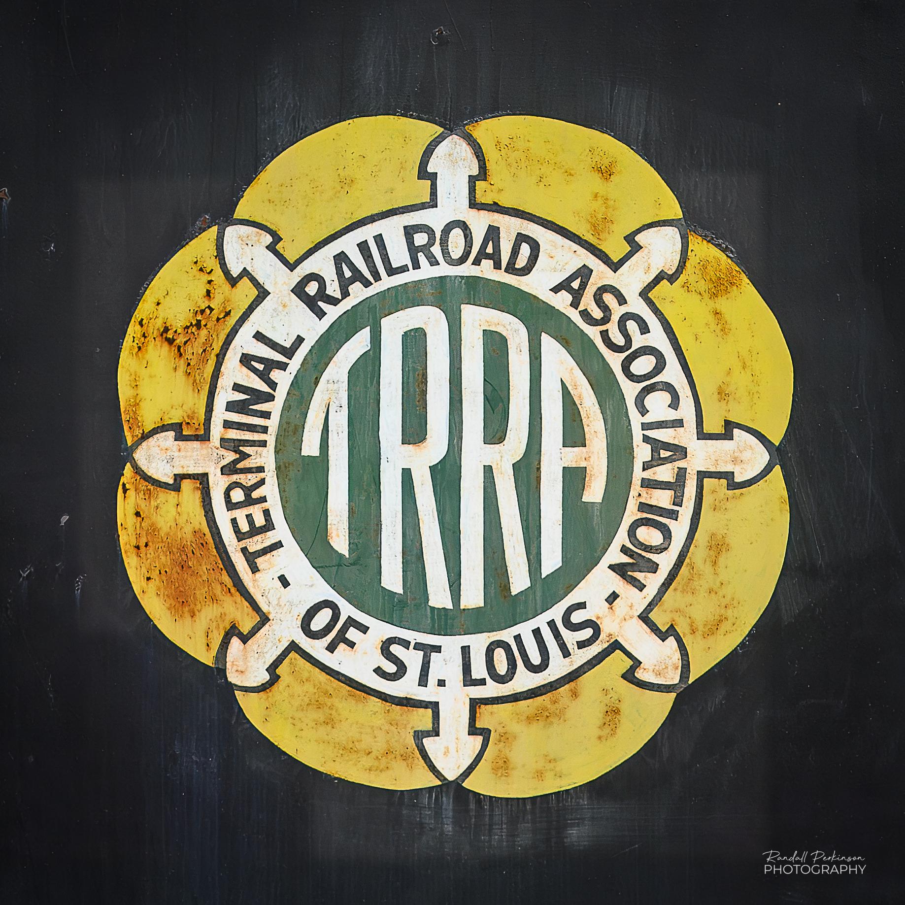 The logo of the Terminal Railroad Association of St. Louis on the side of a locomotive.