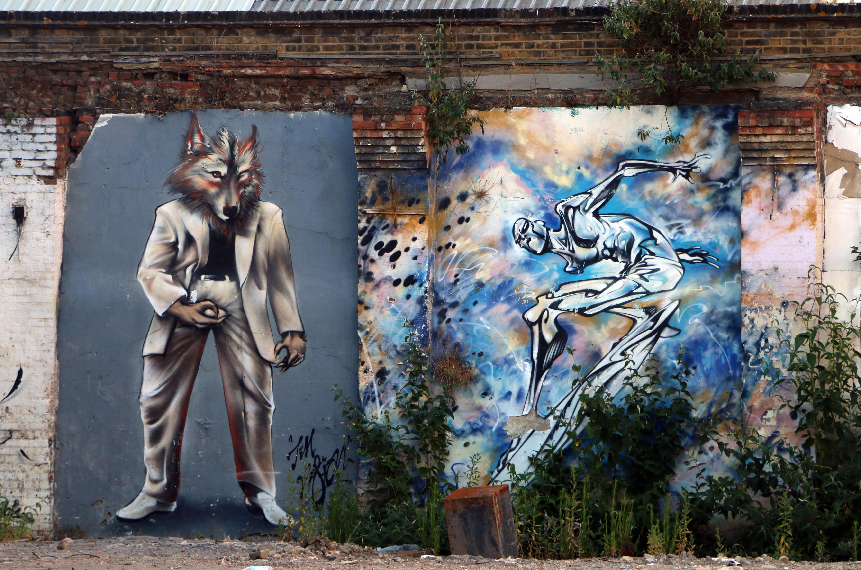 Two panels of plaster, once an interior wall now exposed by demolition. To the left a wolf or werewolf in a white or grey suit over a black t-shirt and white shoes. Its right hand it grabbing its crotch more than suggestively. To the right an elongated and distorted figure in black, greys and white that make it look like it is composed of liquid metal against a background of varied blue with lighter orange tinged cloud and black artefacts, a chaotic sky.


Canon EOS 70D
ISO: 200
Shutter Speed: 1/200
Aperture: 5.6
Focal Length: 135.0 mm (35 mm equivalent: 228.4 mm)
Hyperfocal Distance: 183.22 m
Field Of View: 9.0 deg

51° 31' 30.6" N, 0° 04' 39.6" W
Shoreditch High Street, London, UK.
2018:06:27 15:46:18
Copyright: Matthew Malthouse © 2018