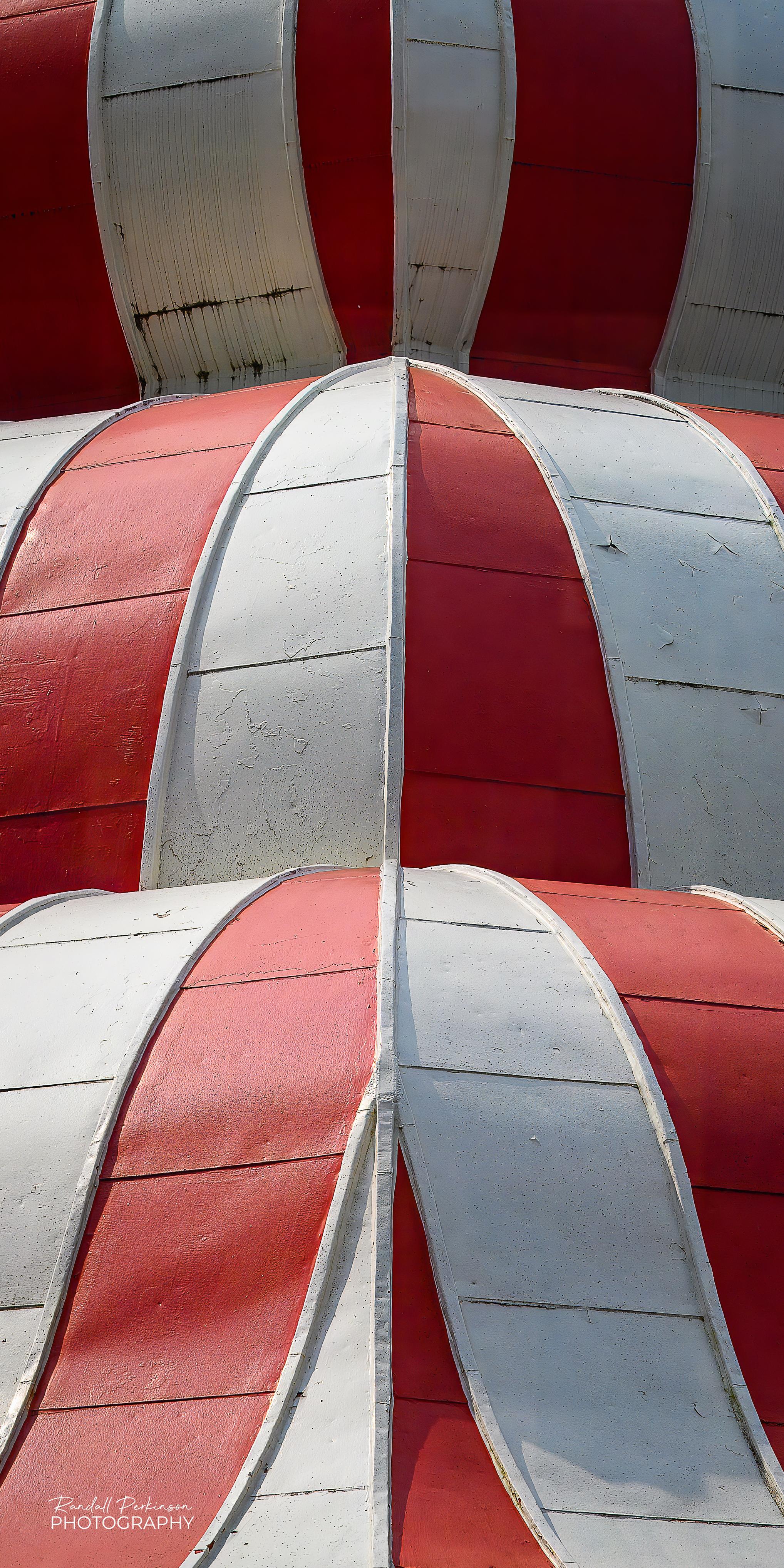 Corner view of three levels of red and white striped metal roofing on the Turkish Pavilion in Tower Grove Park in St. Louis, Missouri.