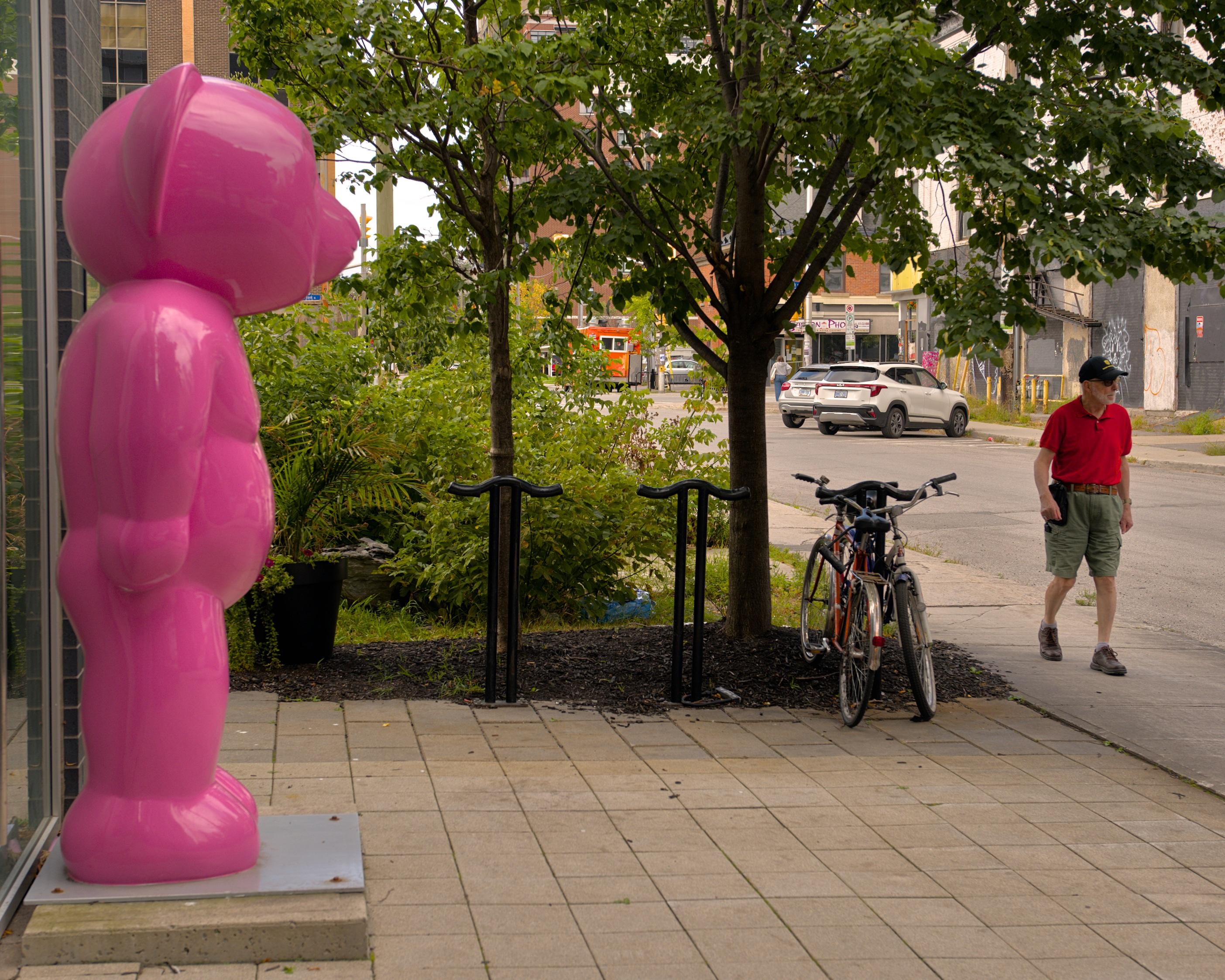 Orange man ignores pink bear.