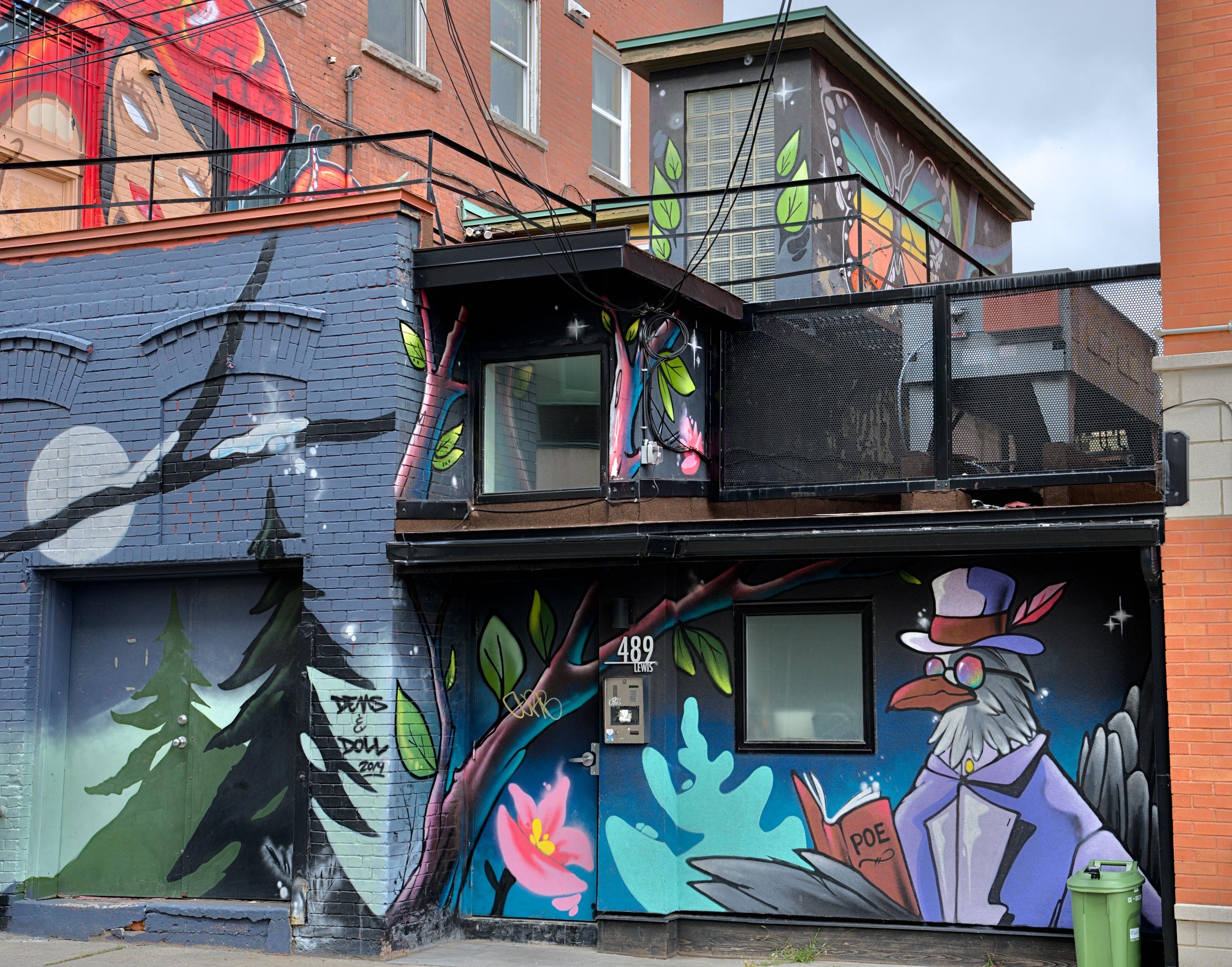 Old brick buildings adorned with murals.