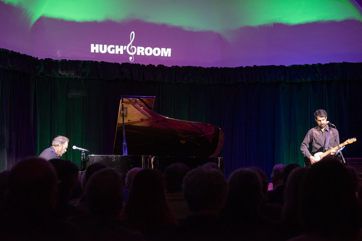 Jimmy plays the piano with Pete Mancini on guitar. I know they are playing MacArthur Park because I saved the green backdrop lights for the sweet green icing flowing down.