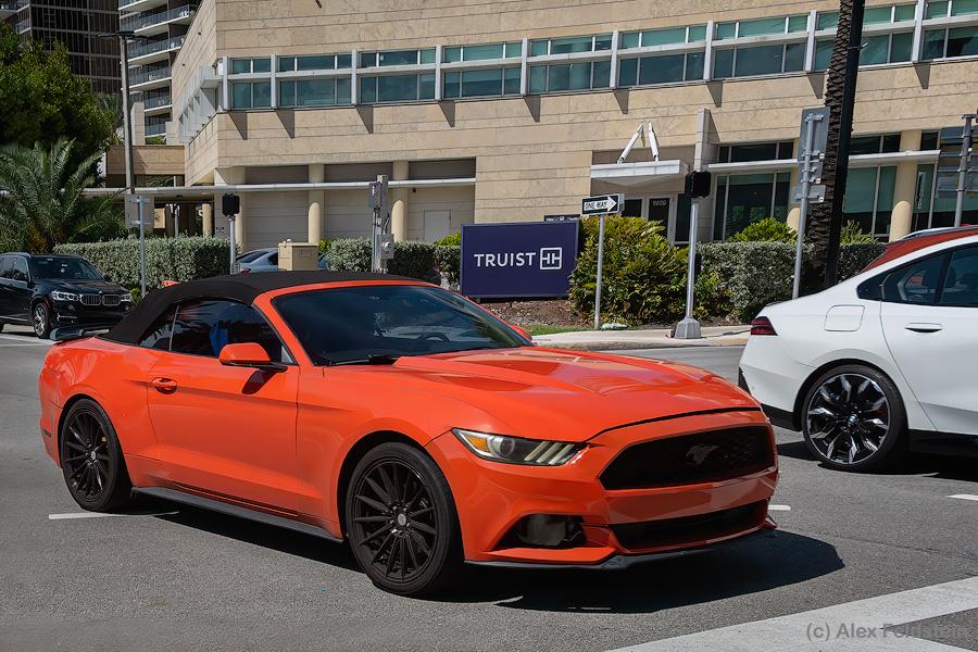 Orange Ford Mustang Convertible driving by