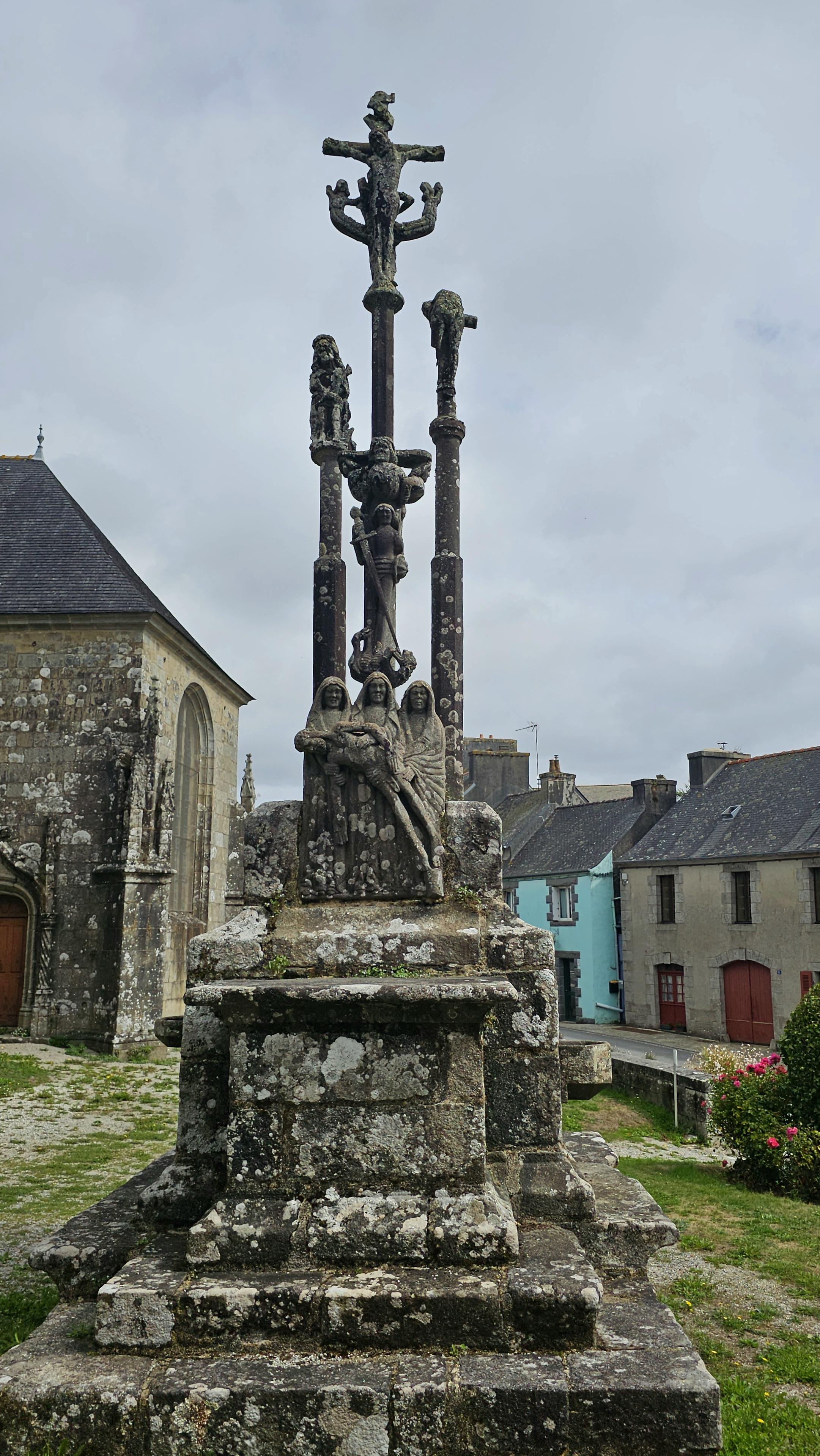 An ornate calvary cross, made of stone.