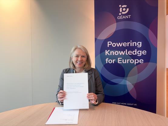 picture of a woman holding up a document